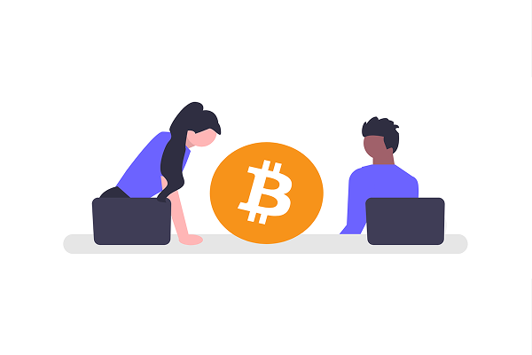 A young woman with long black hair in a ponytail leans down looking at a Bitcoin icon, while a dark skinned young man on a laptop sits on the other side of it